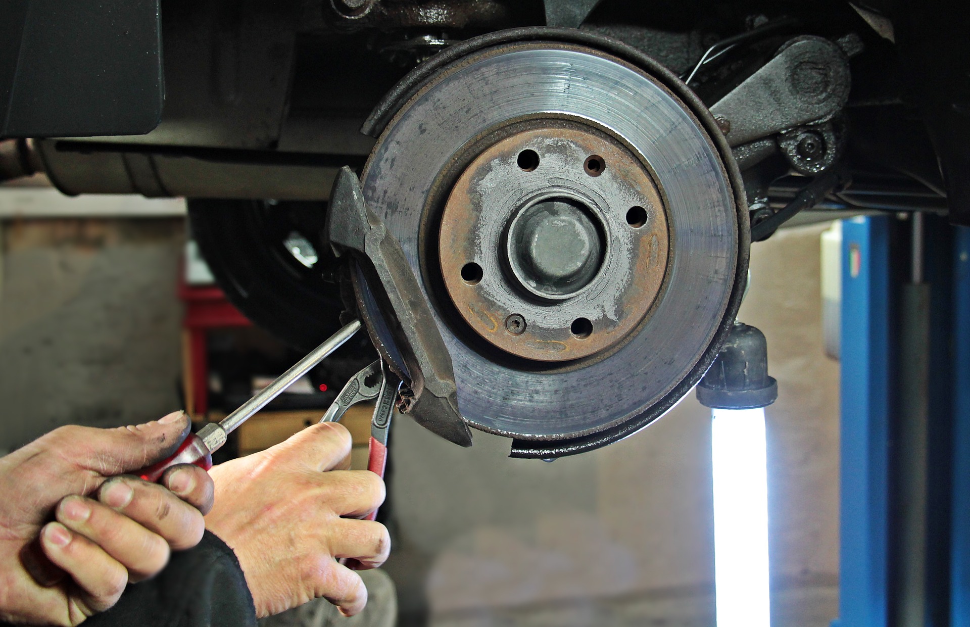 A mechanic repairing a car wheel