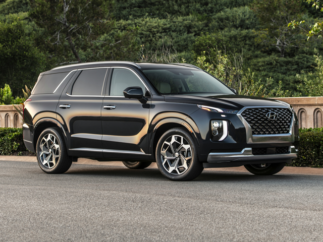 A black Hyundai Palisade driving on the road