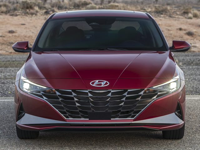 A red Hyundai Elantra parked outside