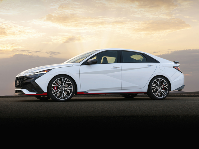 A white Hyundai Elantra N parked outside