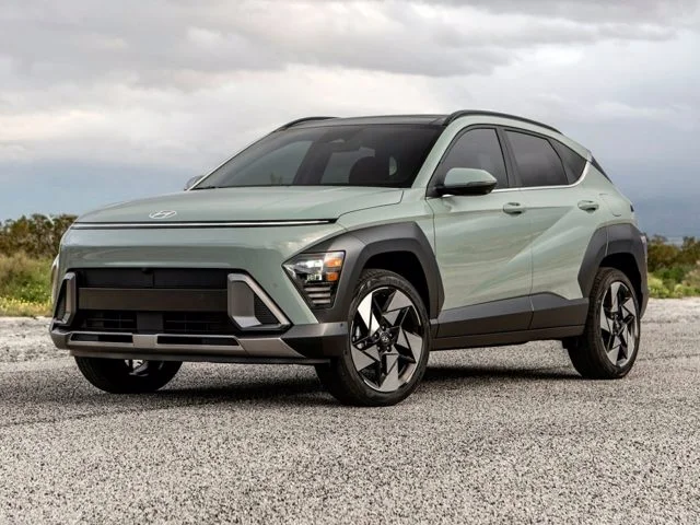 A green Hyundai Kona parked outside