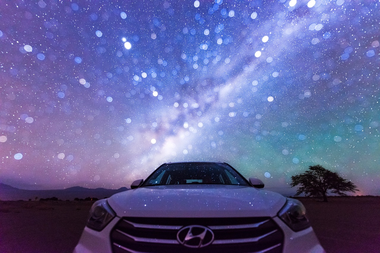 A Hyundai vehicle parked by a star filled night sky