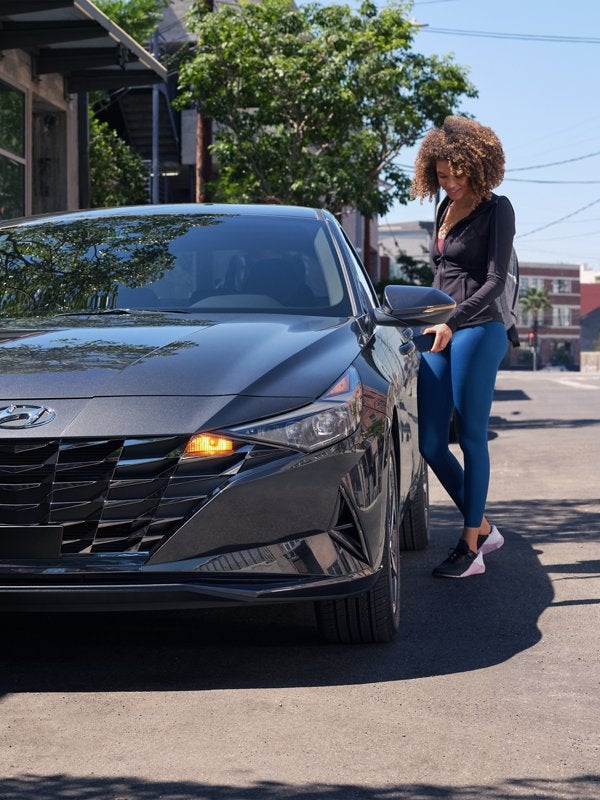 Women open a car door